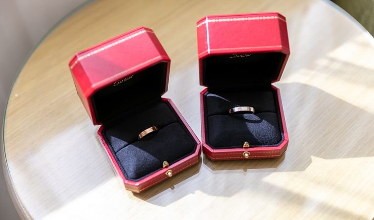 Jewellery box with rings displayed on glass surface