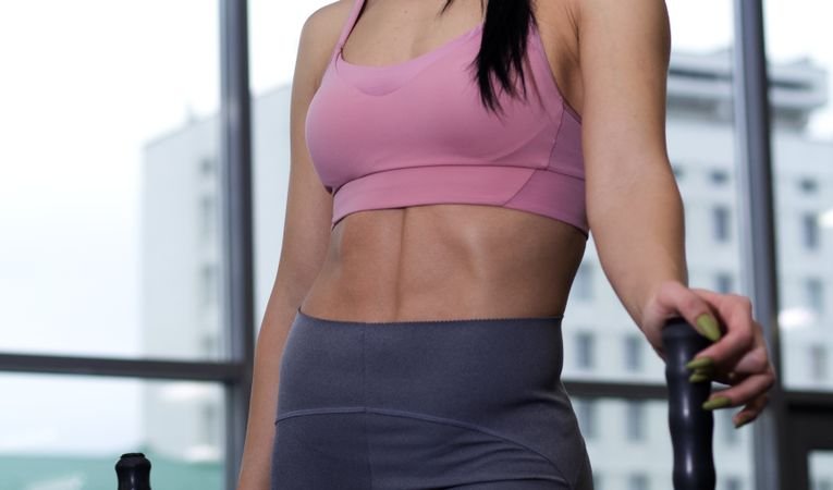 Woman wearing navy gym set leggings and sports bra